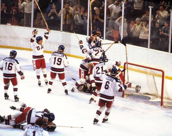 A dramatic image of the U.S. ice hockey team celebrating their victory against the Soviet Union