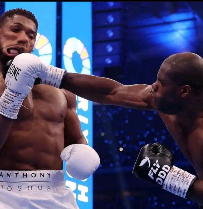 Dubois Celebrating Victory: A powerful image of Daniel Dubois with his arms raised in triumph after knocking out Anthony Joshua, capturing the energy of his victory.